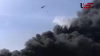 فیلم استفاده از بالگرد برای مهار آتش سوزی بندرشهید رجایی