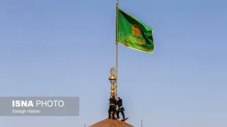 تصاویر تعویض پرچم گنبد حرم مطهر رضوی