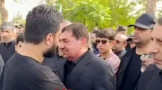 تصاویری غم‌انگیز از فرزند شهید حاجی‌زاده در آغوش مخبر