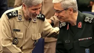 امیر حاتمی در حال نشانه‌گیری با مسلسل در کنار سپهبد باقری